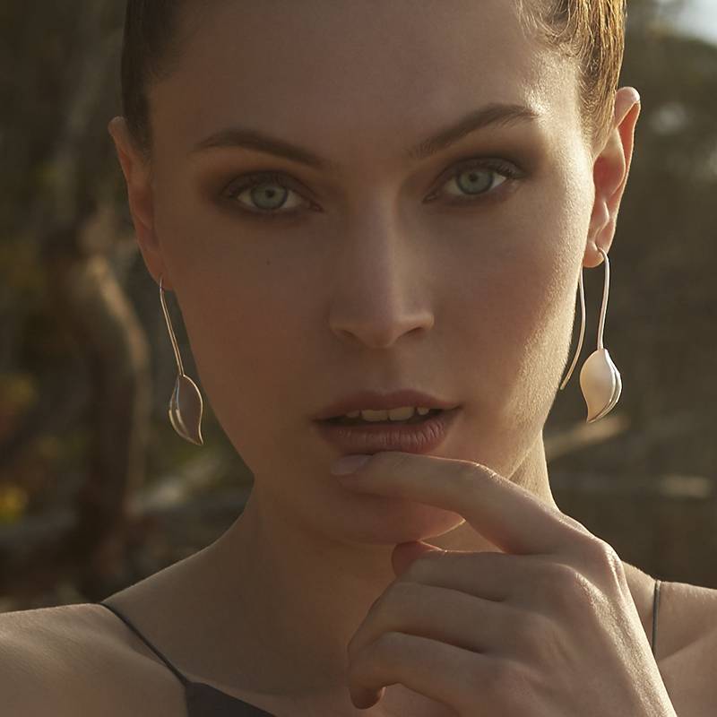 Model wearing Daniel Bentley Grevillea Long Earrings in sterling silver, inspired by the organic form of the seed pod from the Australian Grevillea tree.