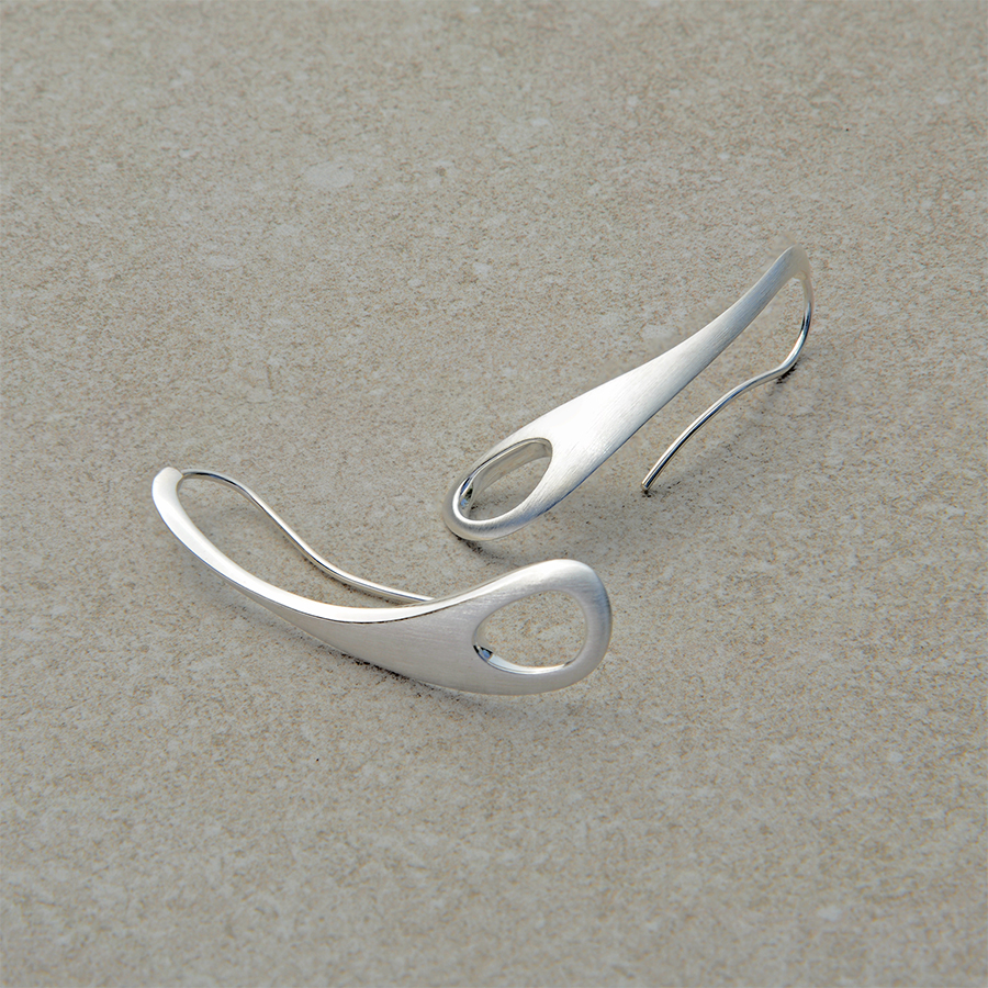 Outback Fossil Earrings in sterling silver, resting on a natural stone background. Sculptural, timeless design inspired by the textures and forms of the Australian landscape.