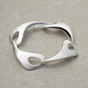 Outback Fossil Large Bracelet in silver on a stone background. Timeless design with flowing, organic curves inspired by the Australian landscape.