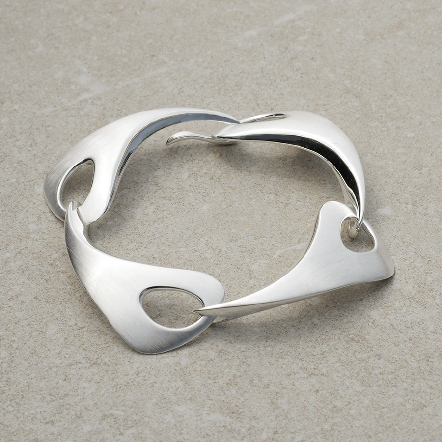 Outback Fossil Large Bracelet in silver on a stone background. Timeless design with flowing, organic curves inspired by the Australian landscape.
