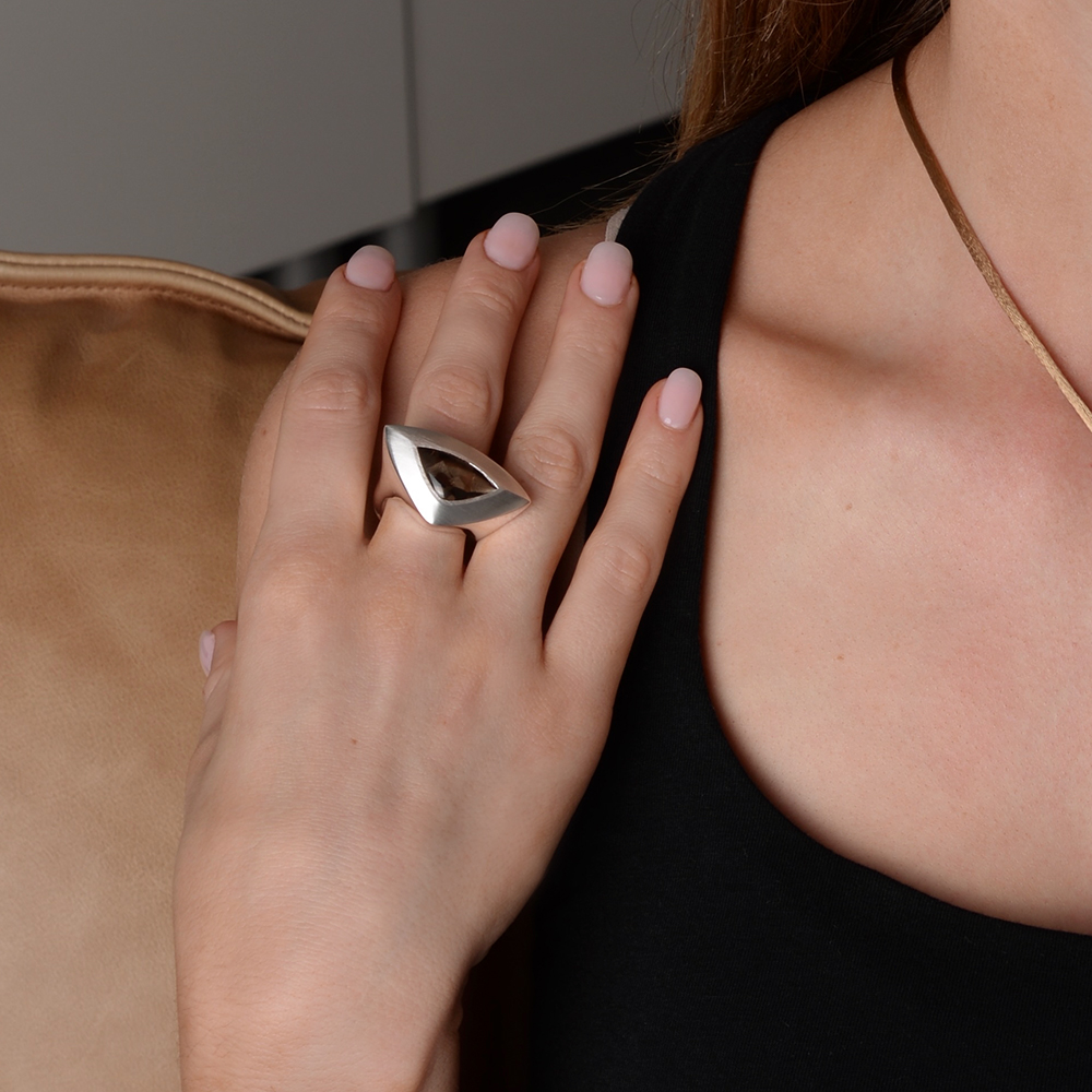 The South Atlantic Ring XL in brushed and polished sterling silver with smokey quartz, worn by model. Striking statement design capturing confidence and coastal energy.