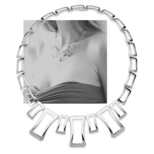 The Deanna Necklace in polished sterling silver with image of model wearing it. Elegant, balanced design inspired by Greek columns, resting gracefully along the neckline.