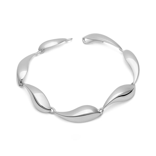 This beautifully sculpted bracelet in silver emulates the arched back of the whales as they surface for air on their journey