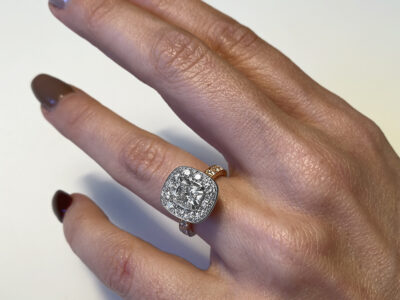 Bespoke diamond engagement ring by Daniel Bentley Jewellery in white and yellow gold with signature fluted design, shown on the finger.