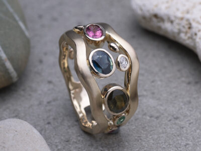 One-of-a-kind bespoke gold ring by Daniel Bentley Jewellery, crafted with multiple gemstones in a distinctive design.